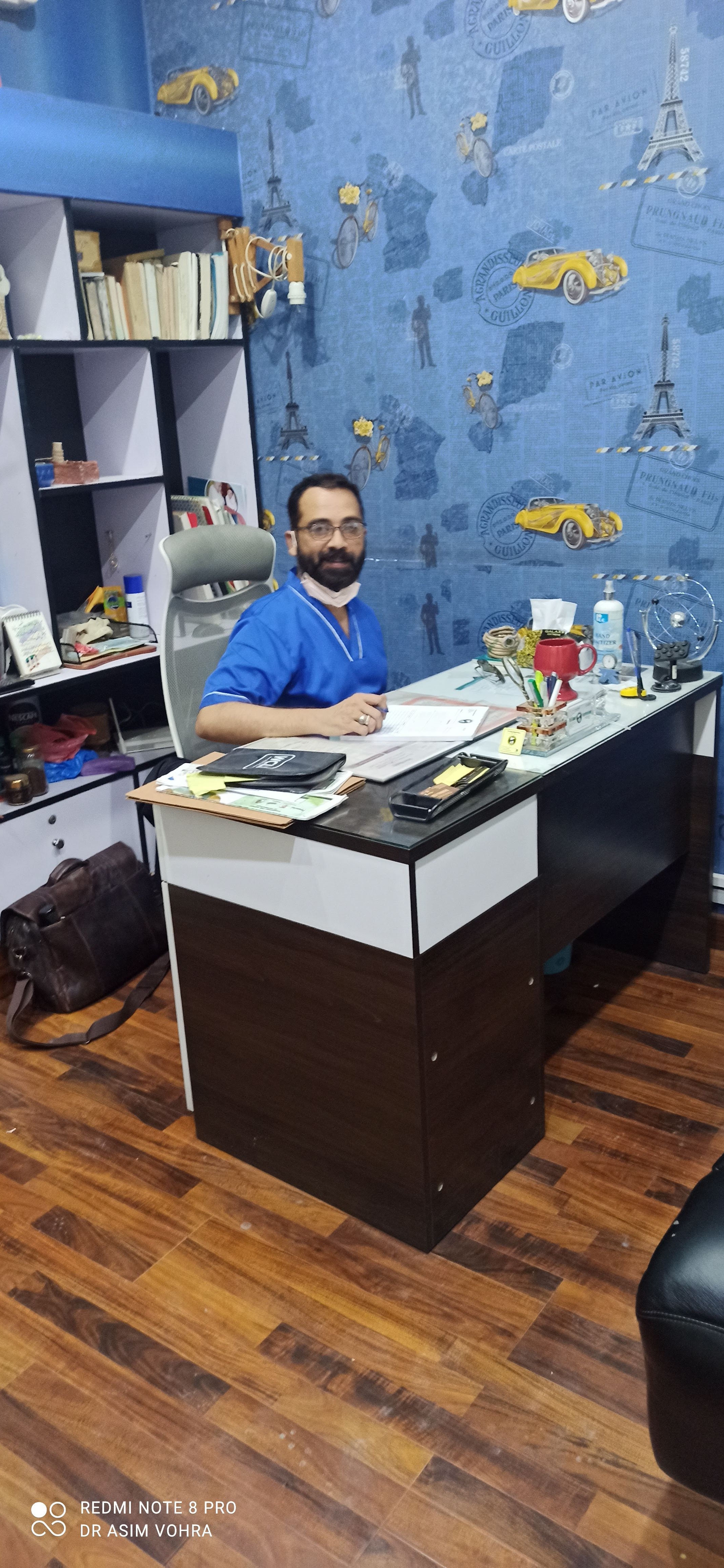 Dr. Asim Habib Vohra at his consultation desk in the clinic